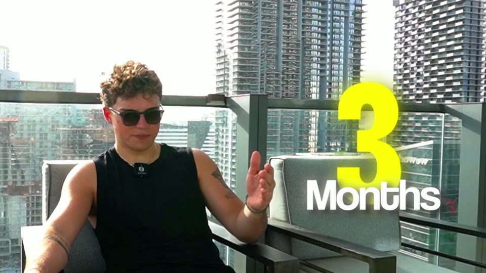 Interview on a balcony with large animated numbers